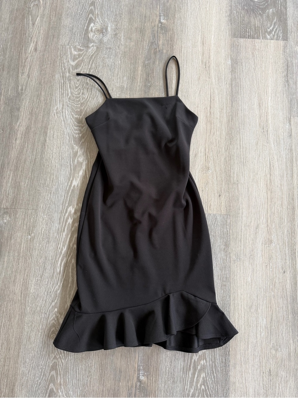 Sleek Black Spaghetti-Strap Mini Dress with Flounce Hem